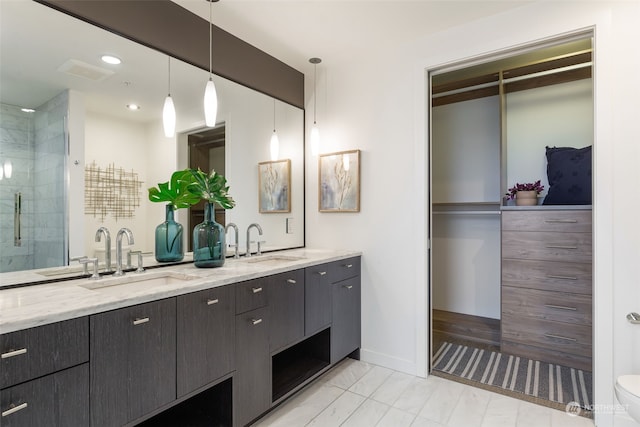 bathroom with a shower with shower door and vanity