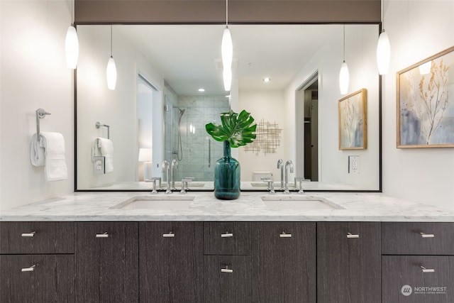 bathroom with a shower with shower door and vanity