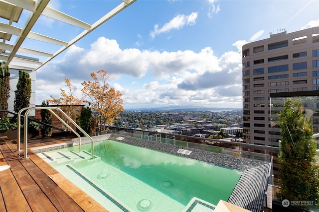 view of swimming pool with a hot tub