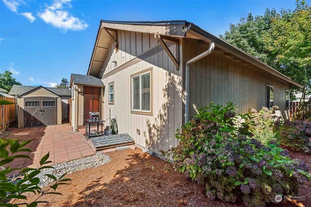 rear view of house featuring a shed and a patio area