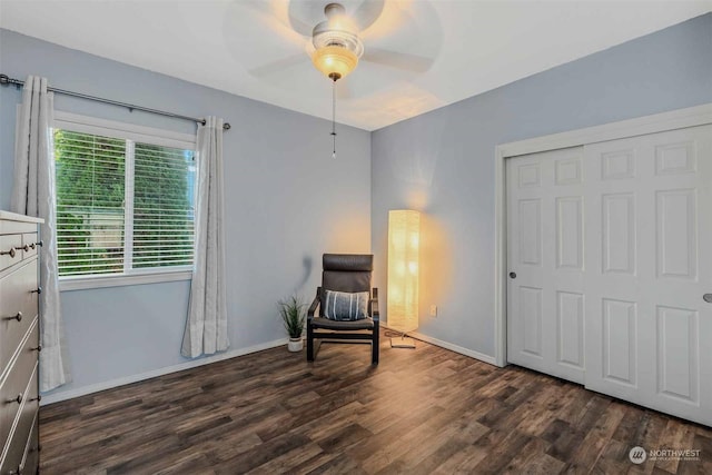 living area featuring dark hardwood / wood-style flooring and ceiling fan