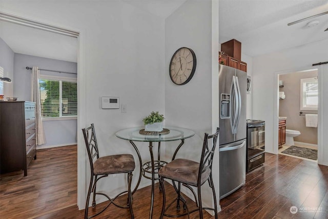 dining space with dark hardwood / wood-style flooring, ceiling fan, and a wealth of natural light