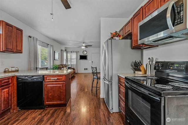 kitchen featuring black appliances, dark hardwood / wood-style flooring, kitchen peninsula, and ceiling fan