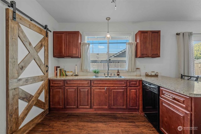 kitchen with dishwasher, dark hardwood / wood-style floors, decorative light fixtures, a barn door, and sink