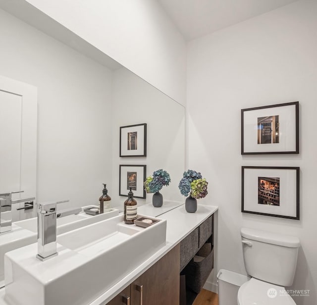 bathroom with toilet and vanity