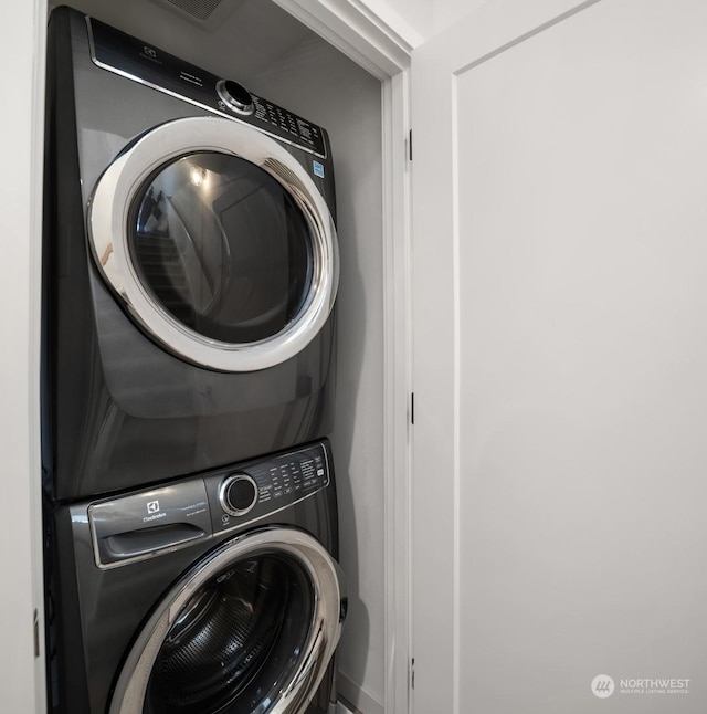 clothes washing area with stacked washer / drying machine