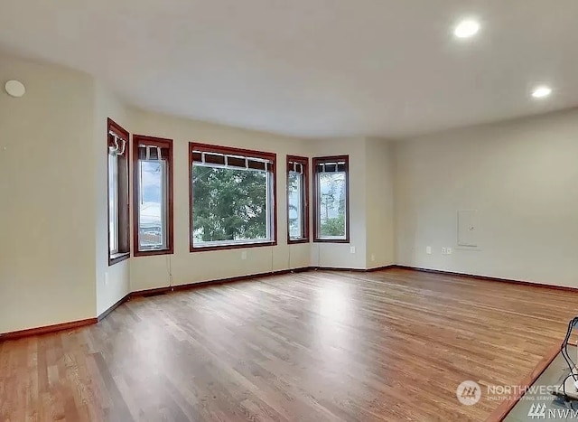 unfurnished room with hardwood / wood-style flooring