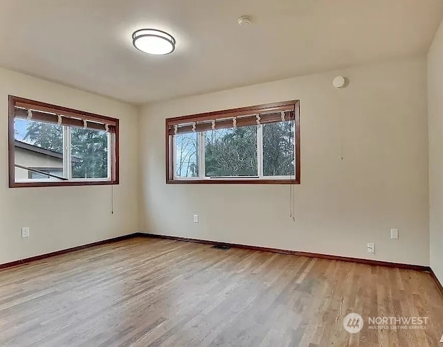 spare room featuring light wood-type flooring