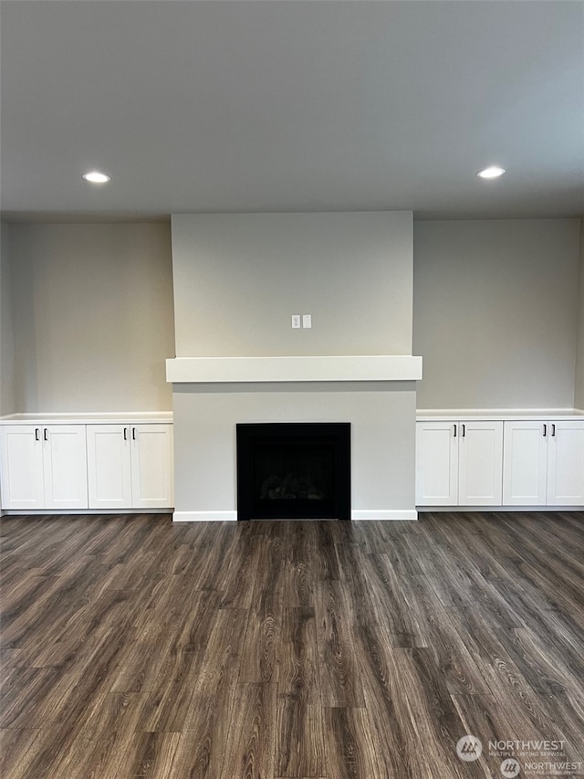 unfurnished living room with dark hardwood / wood-style floors