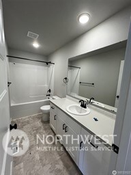 full bathroom with vanity, toilet, and shower / bathtub combination