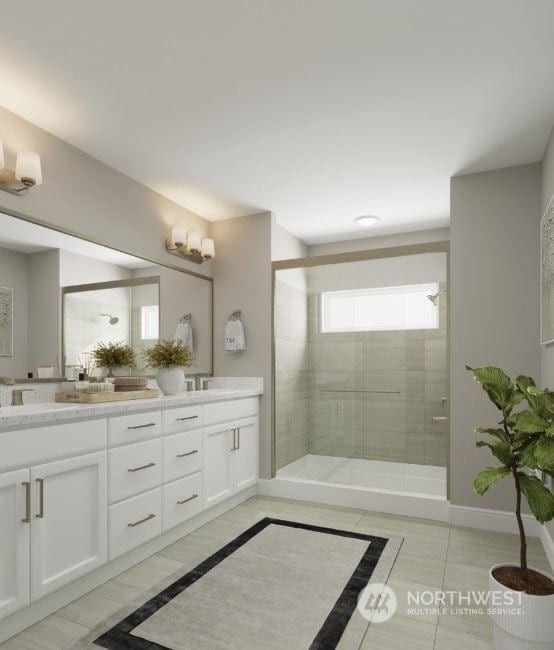 bathroom featuring a shower with door, tile patterned floors, and vanity