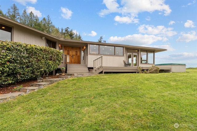 back of house featuring a yard and french doors