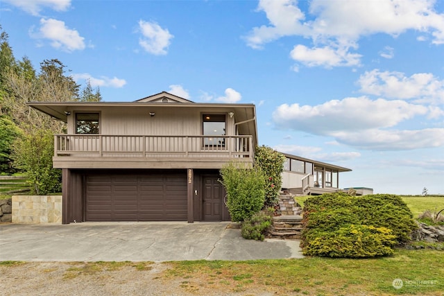 view of front of home featuring a garage and a balcony