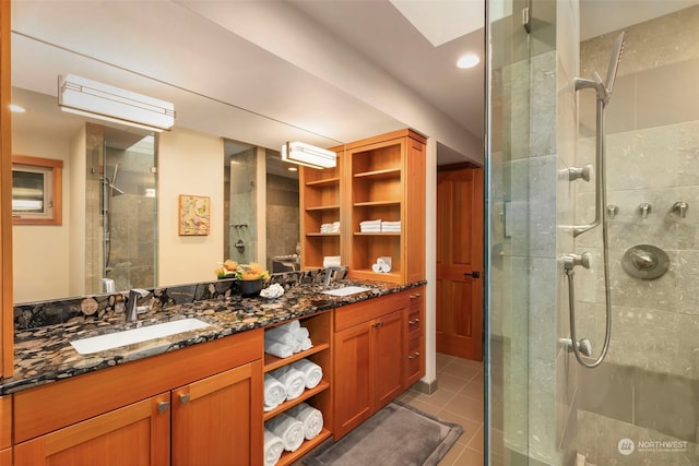 bathroom featuring tile patterned floors, vanity, and walk in shower