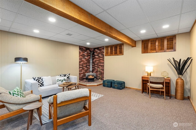 living room featuring carpet flooring and a wood stove