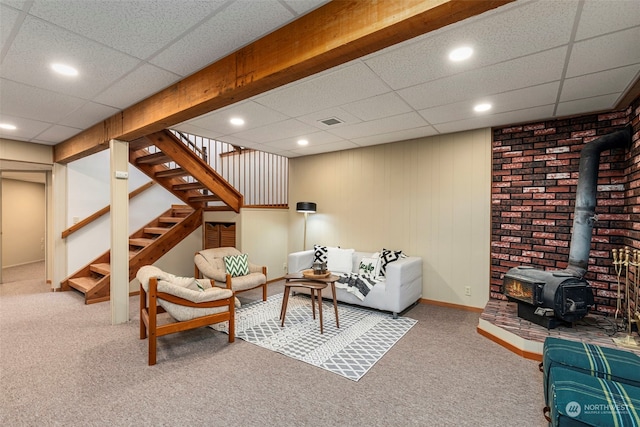 carpeted living room with a wood stove