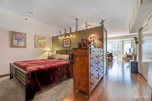 bedroom featuring lofted ceiling and light hardwood / wood-style floors