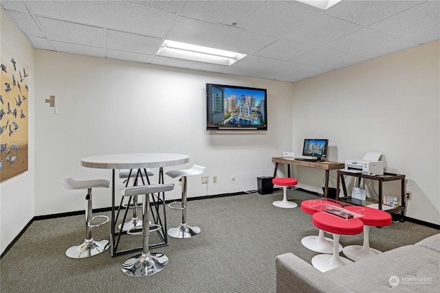 recreation room with carpet floors and a drop ceiling