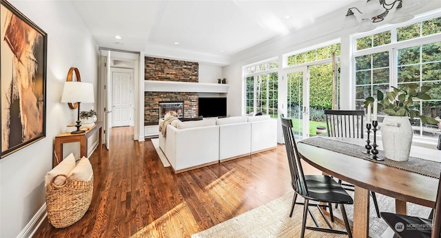 living room featuring dark hardwood / wood-style flooring and a fireplace