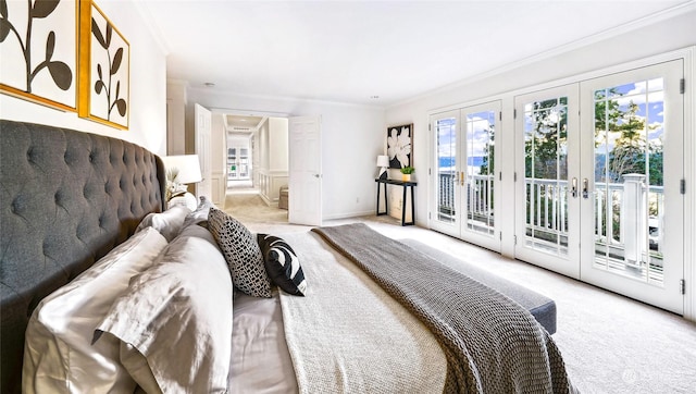 carpeted bedroom featuring access to exterior, crown molding, and french doors