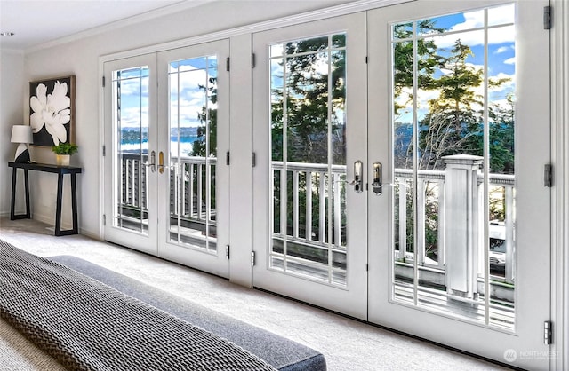 entryway with a water view, french doors, carpet floors, and ornamental molding