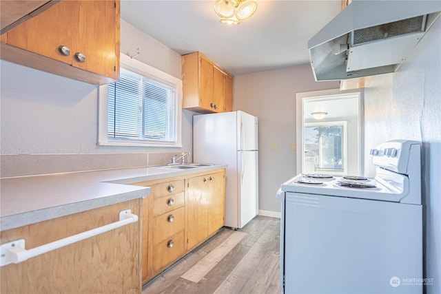 kitchen with plenty of natural light, sink, exhaust hood, and white appliances