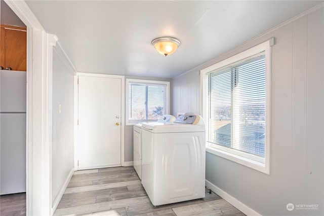 washroom featuring separate washer and dryer and light hardwood / wood-style flooring