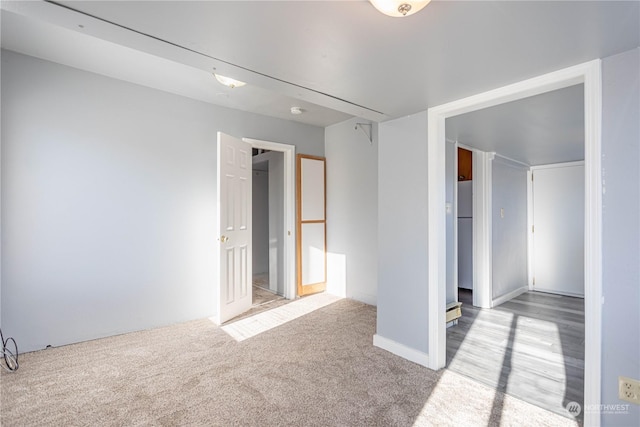 spare room featuring light colored carpet