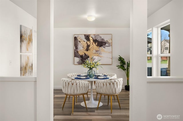 dining room with baseboards and wood finished floors