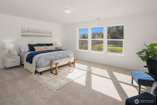 carpeted bedroom featuring visible vents