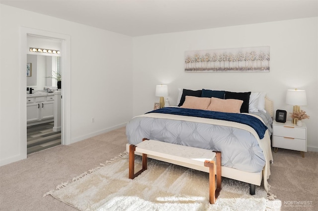 bedroom with carpet, connected bathroom, and baseboards