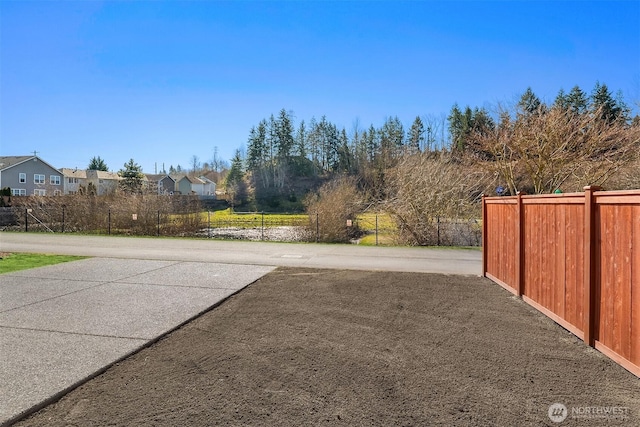 view of yard with a residential view and fence