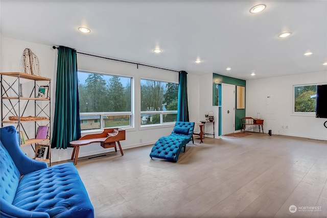 sitting room with wood-type flooring