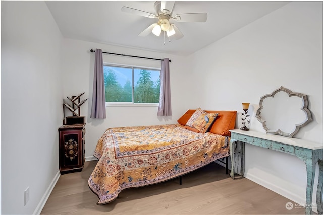 bedroom with ceiling fan and hardwood / wood-style flooring