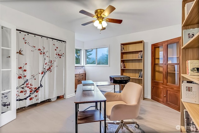 sitting room with ceiling fan and french doors