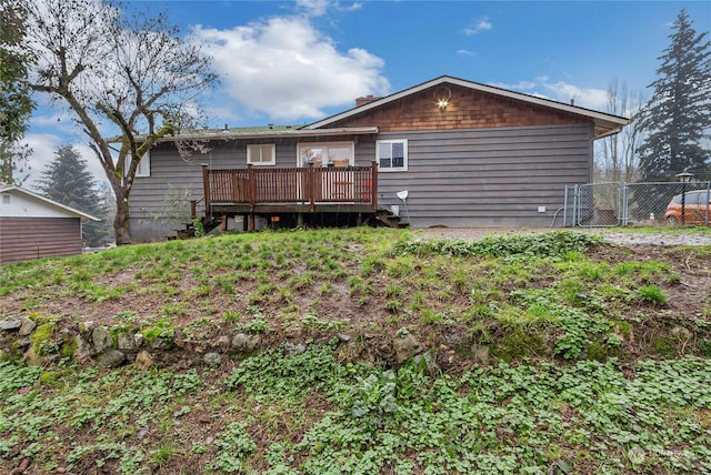 rear view of property with a wooden deck