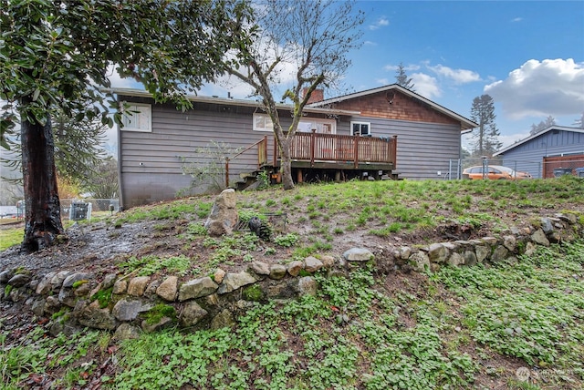 back of property with a wooden deck