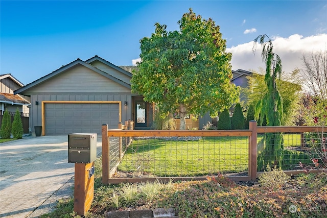 view of front of house featuring a fenced front yard, an attached garage, board and batten siding, a front yard, and driveway