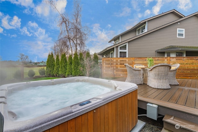 exterior space with outdoor dining area and a hot tub