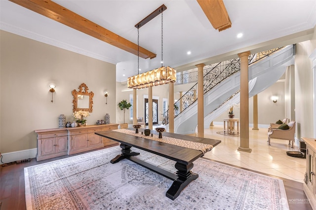 tiled dining room featuring crown molding, an inviting chandelier, and decorative columns