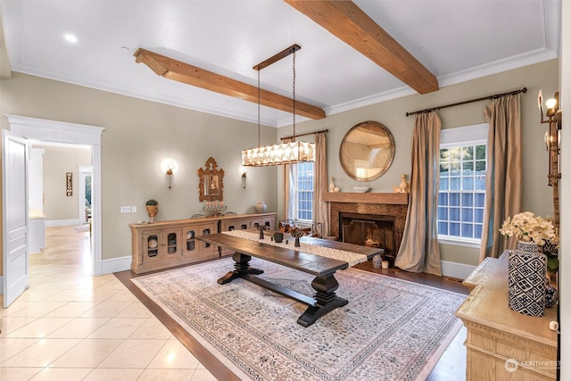 tiled dining area featuring beam ceiling, a premium fireplace, and ornamental molding