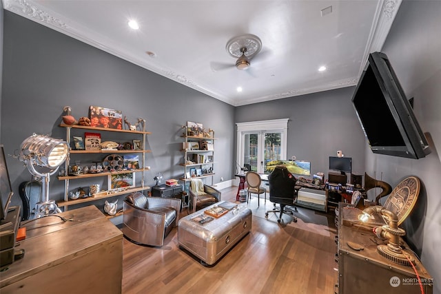 living room with ceiling fan, crown molding, and wood-type flooring