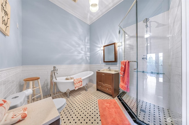 bathroom featuring tile walls, plus walk in shower, tile patterned floors, ornamental molding, and vanity