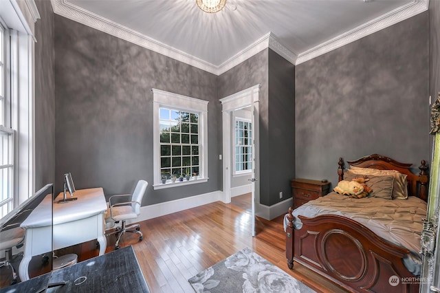 bedroom with wood-type flooring and ornamental molding