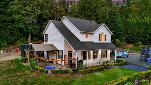 back of house with cooling unit and a yard