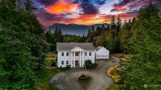 greek revival inspired property featuring a garage and a mountain view