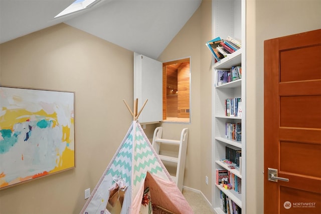 recreation room featuring lofted ceiling, carpet floors, and built in features