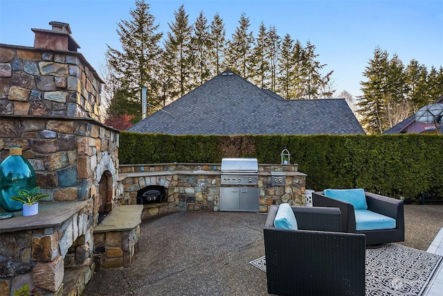 view of patio featuring an outdoor kitchen, grilling area, and an outdoor stone fireplace