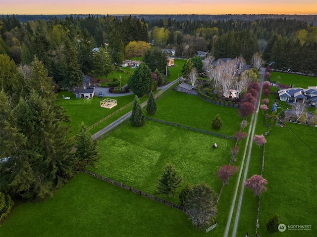 aerial view at dusk featuring a rural view