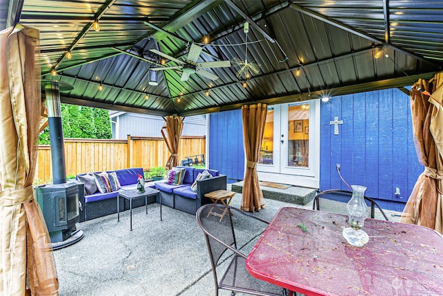 view of patio featuring a gazebo, an outdoor hangout area, ceiling fan, and french doors